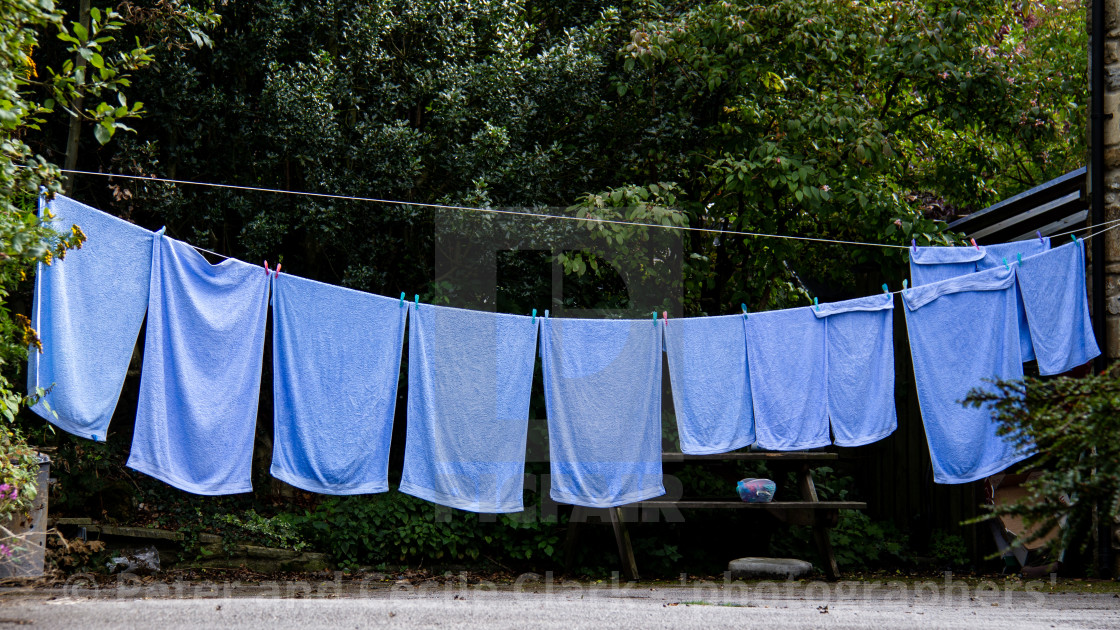 "Blue Towels Hanging out to Dry on Washing Line in Kettlewell a Yorkshire Dales Village." by Peter and Cecile Clark - 'photographers' - $12.70 "Blue Towels Hanging out to Dry on Washing Line in Kettlewell a Yorkshire Dales Village." stock image