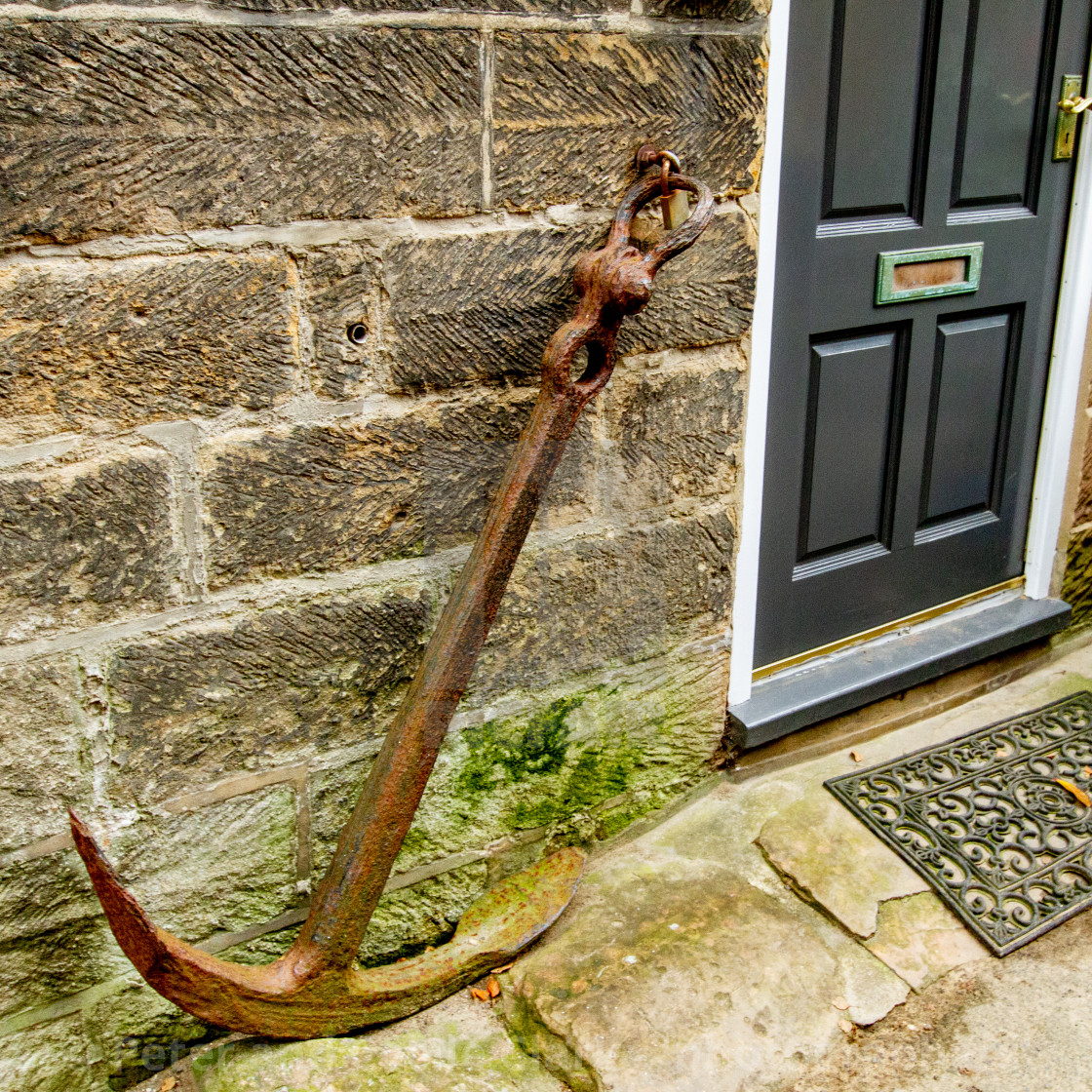 "Old Kedge Anchor as decoration next to Robin Hoods Bay Cottage Entrance." stock image