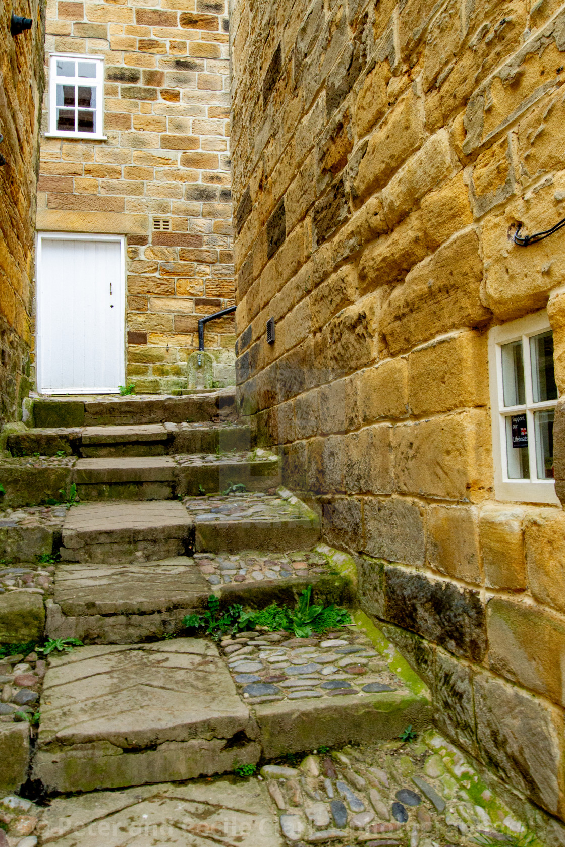 "Robin Hoods Bay, Yorkshire East Coast, England. Narrow Ginnel with Steps and Cobbles." stock image