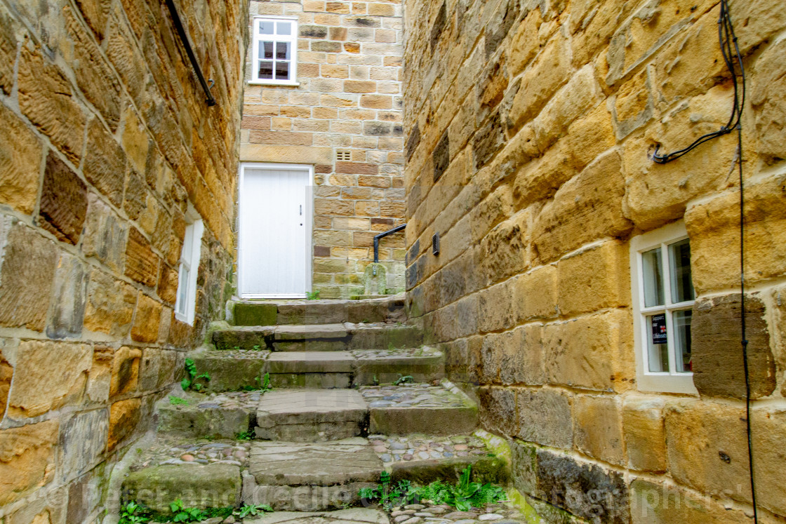 "Robin Hoods Bay, Yorkshire East Coast, England. Narrow Ginnel with Steps and Cobbles." stock image