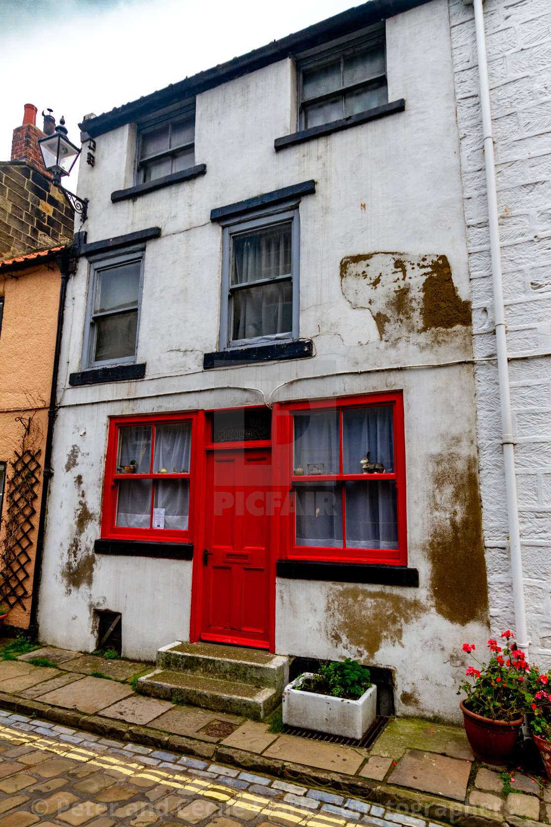 "Staithes, Yorkshire East Coast, England, High Street, Cottage with Red Entrance Door" stock image