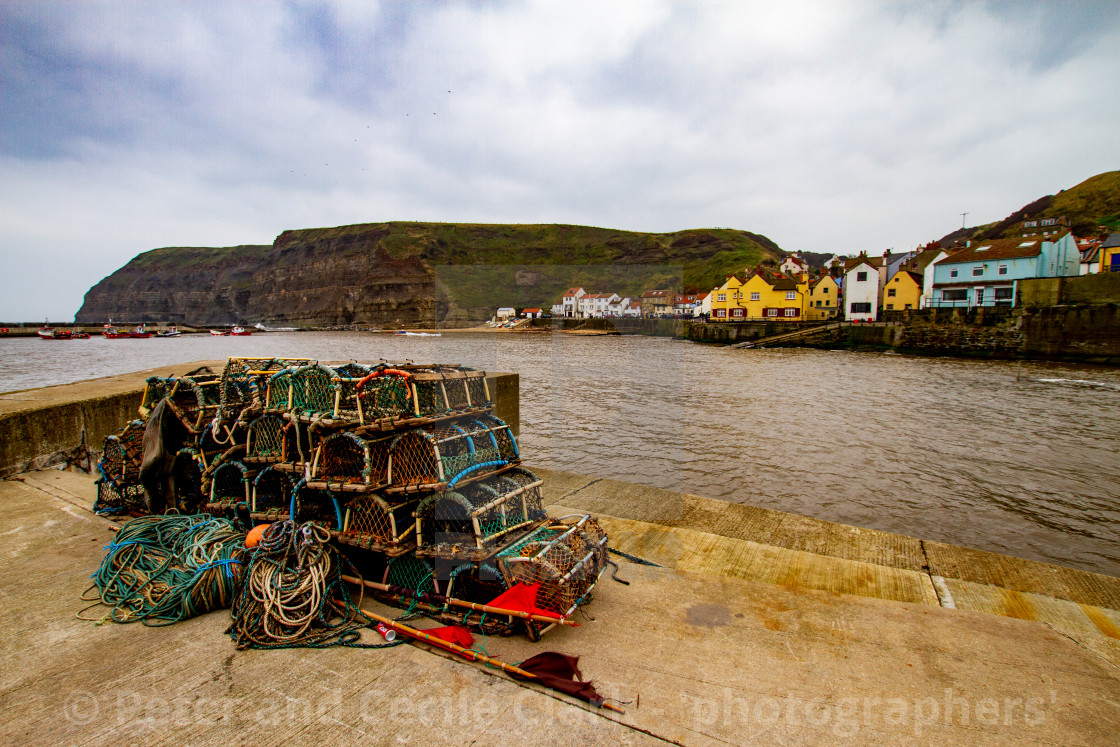 "View Across Staithes Harbour towards the small sandy beach and the Cod and Lobster Pub." stock image