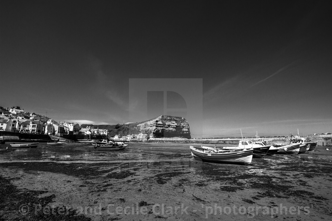 "Staithes and Cowbar Nab, Fishing Boats to the Foreground. Yorkshire Coast, England. (monochrome)" stock image