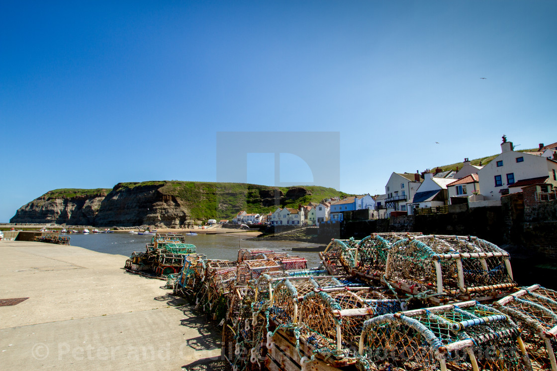 "Lobster Pots Stacked on North Side of Staithes Harbour, Yorkshire, England." stock image