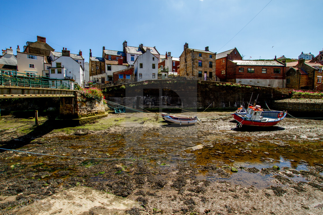 "Staithes Footbridge and Moored Fishing Boats in Staithes Beck, Yorkshire, England." stock image