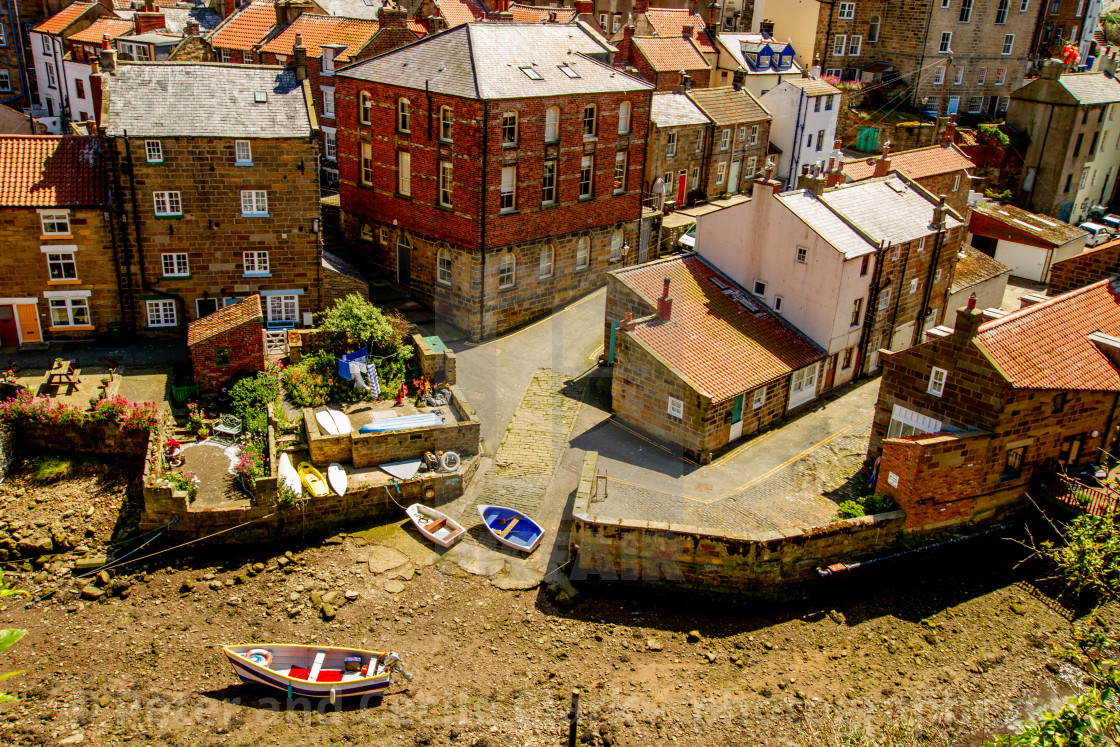 "Moored Fishing Boat in Staithes Beck, Slipway and Cottages to the Background. Staithes, Yorkshire, England." stock image