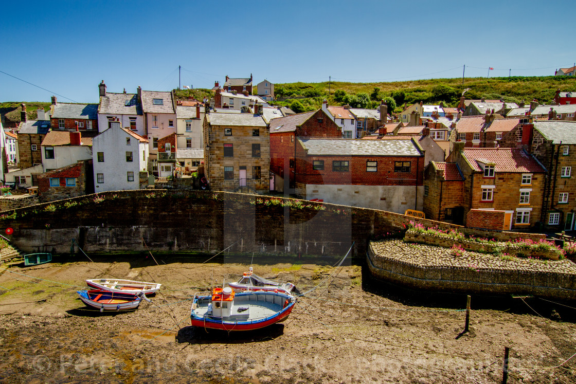 "Moored Fishing Boats in Staithes Beck, Cottages to the Background. Staithes, Yorkshire, England." stock image