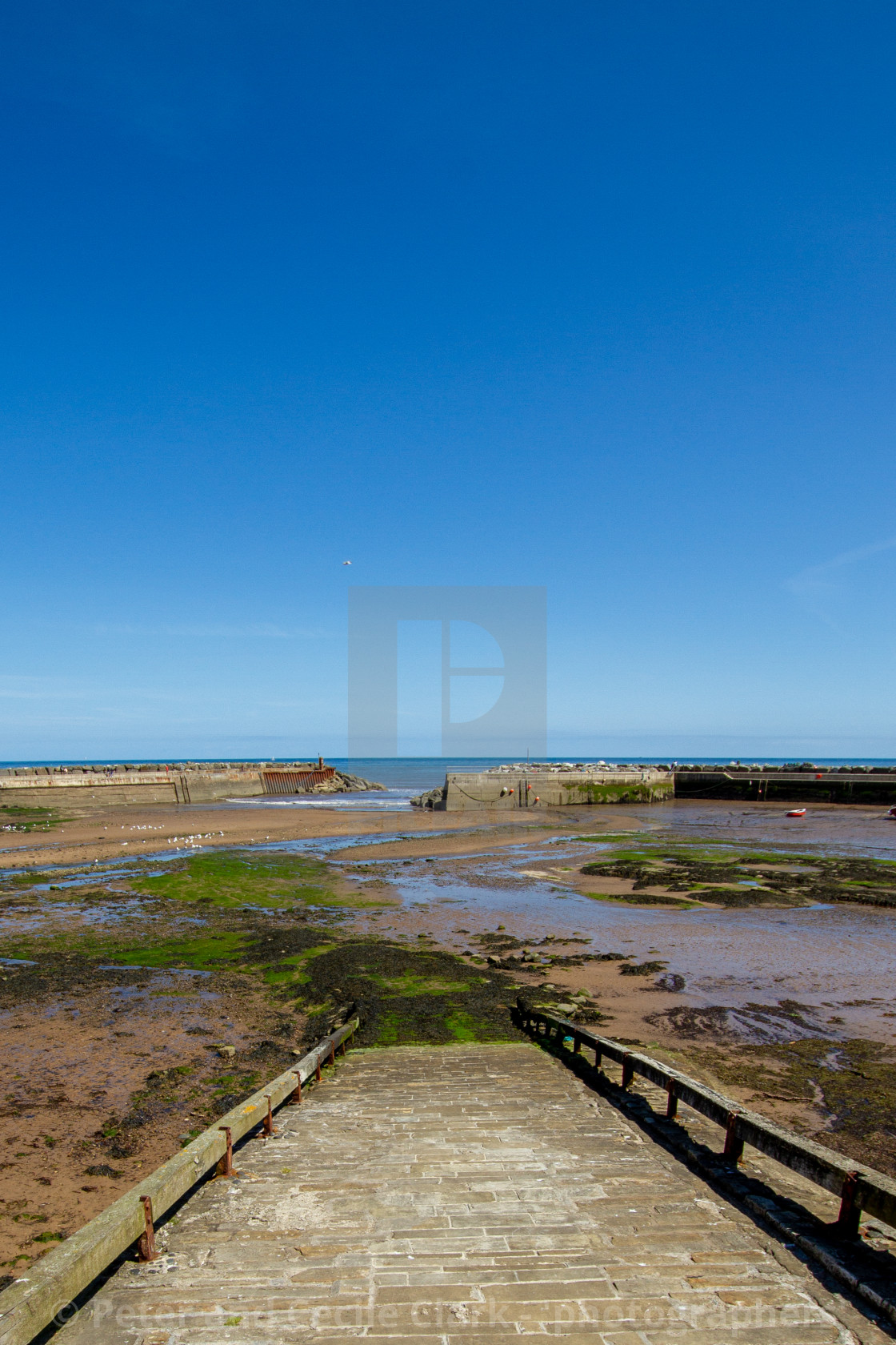 "Staithes Harbour at Low Tide, Slipway to the foreground, Yorkshire, England." stock image