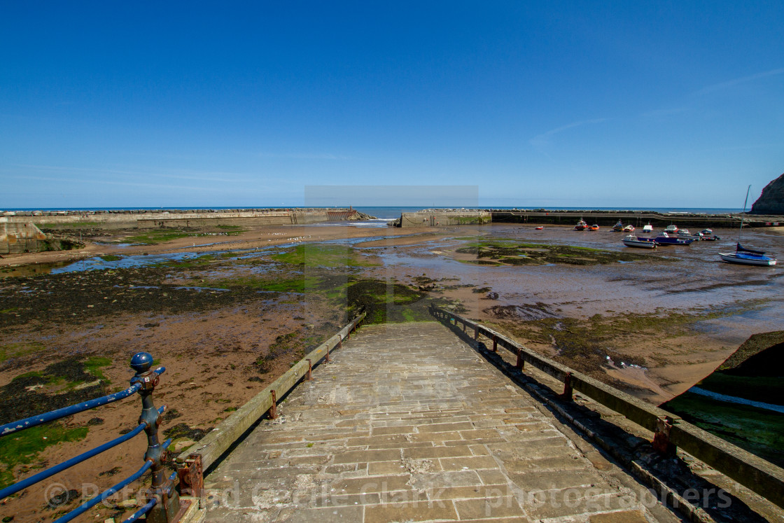 "Staithes Harbour at Low Tide, Slipway to the foreground, Yorkshire, England." stock image