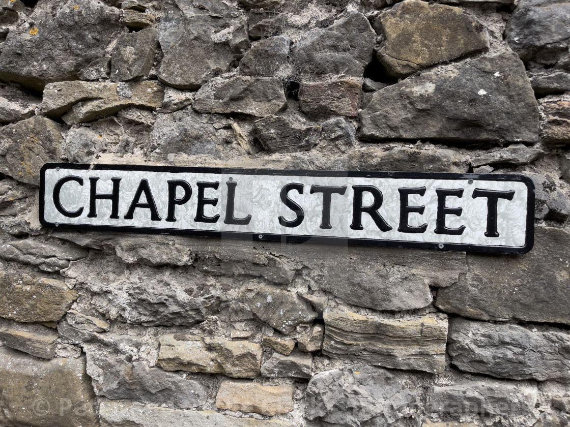 "Grassington, Chapel Street Sign on Stone Background." stock image