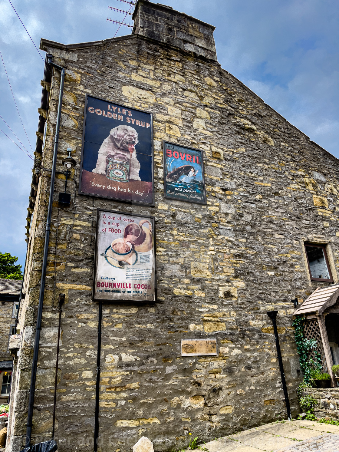 "Grassington, Stone Gable End Advertising Boards." stock image