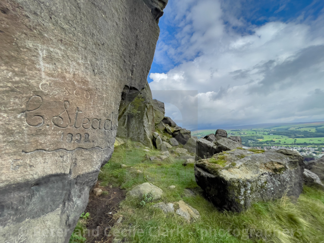 "Cow and Calf Rocks, Name Carving, Ilkley." by Peter and Cecile Clark - 'photographers' - $25.10 "Cow and Calf Rocks, Name Carving, Ilkley." stock image