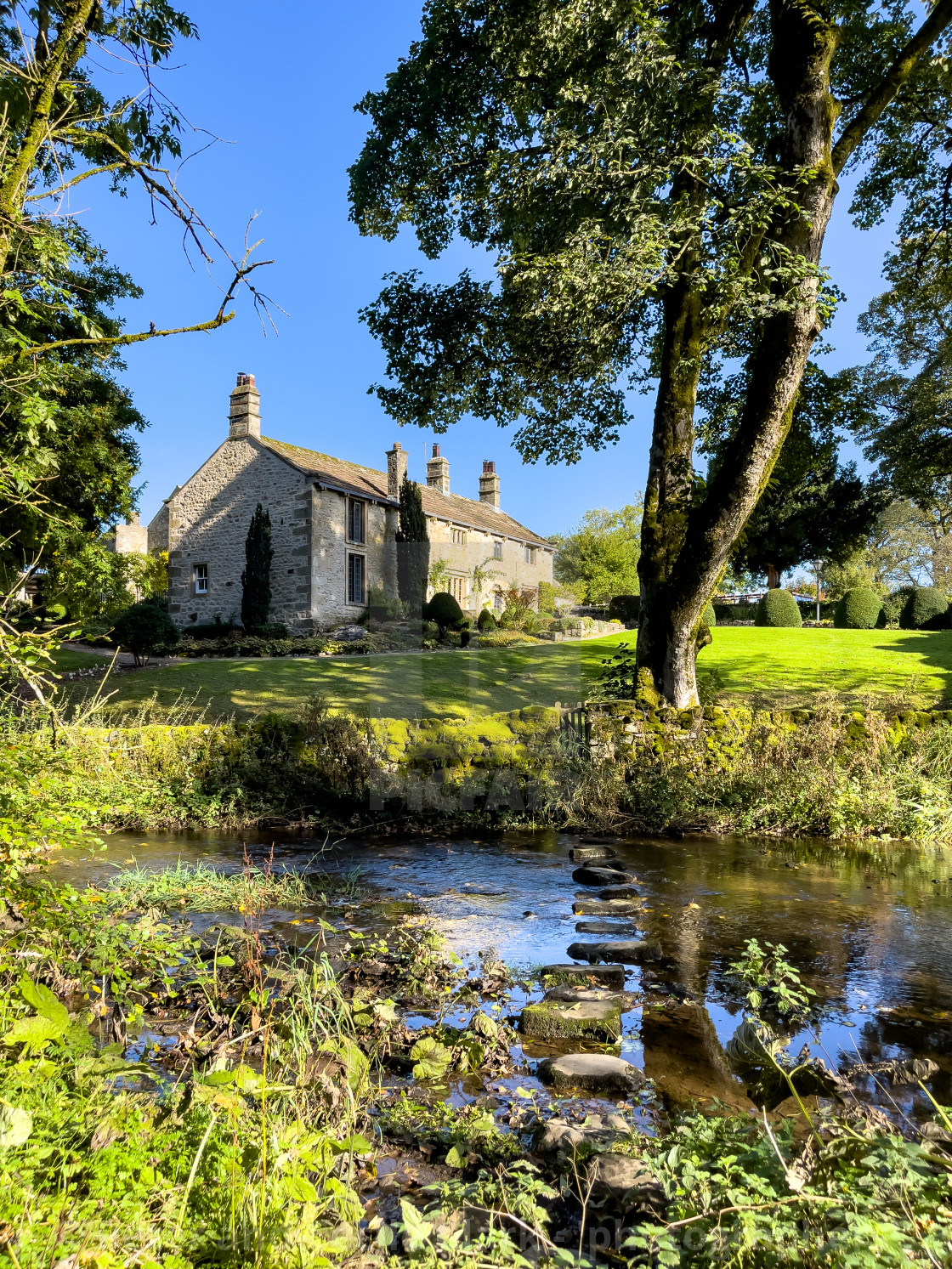 "Idyllic Yorkshire Cottage, Stream and Stepping Stones over Linton Beck." stock image