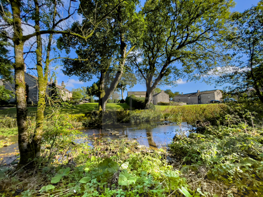 "Idyllic Yorkshire Cottage and Stepping Stones over Linton Beck." stock image