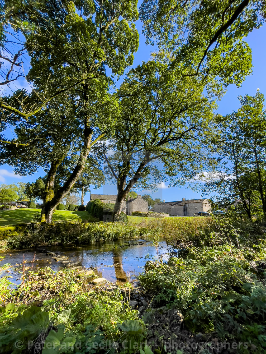 "Idyllic Yorkshire Cottage and Stepping Stones over Linton Beck." stock image