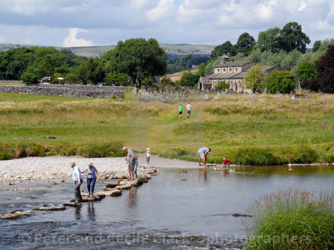 "Parish Church, Linton in Craven and River Wharfe stepping stones." by Peter and Cecile Clark - 'photographers' - $10.11 "Parish Church, Linton in Craven and River Wharfe stepping stones." stock image