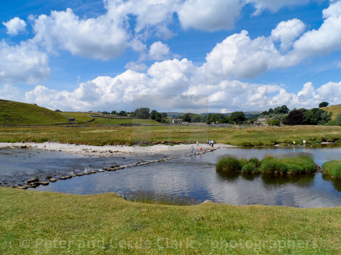 "Parish Church, Linton in Craven and River Wharfe stepping stones." by Peter and Cecile Clark - 'photographers' - $10.10 "Parish Church, Linton in Craven and River Wharfe stepping stones." stock image
