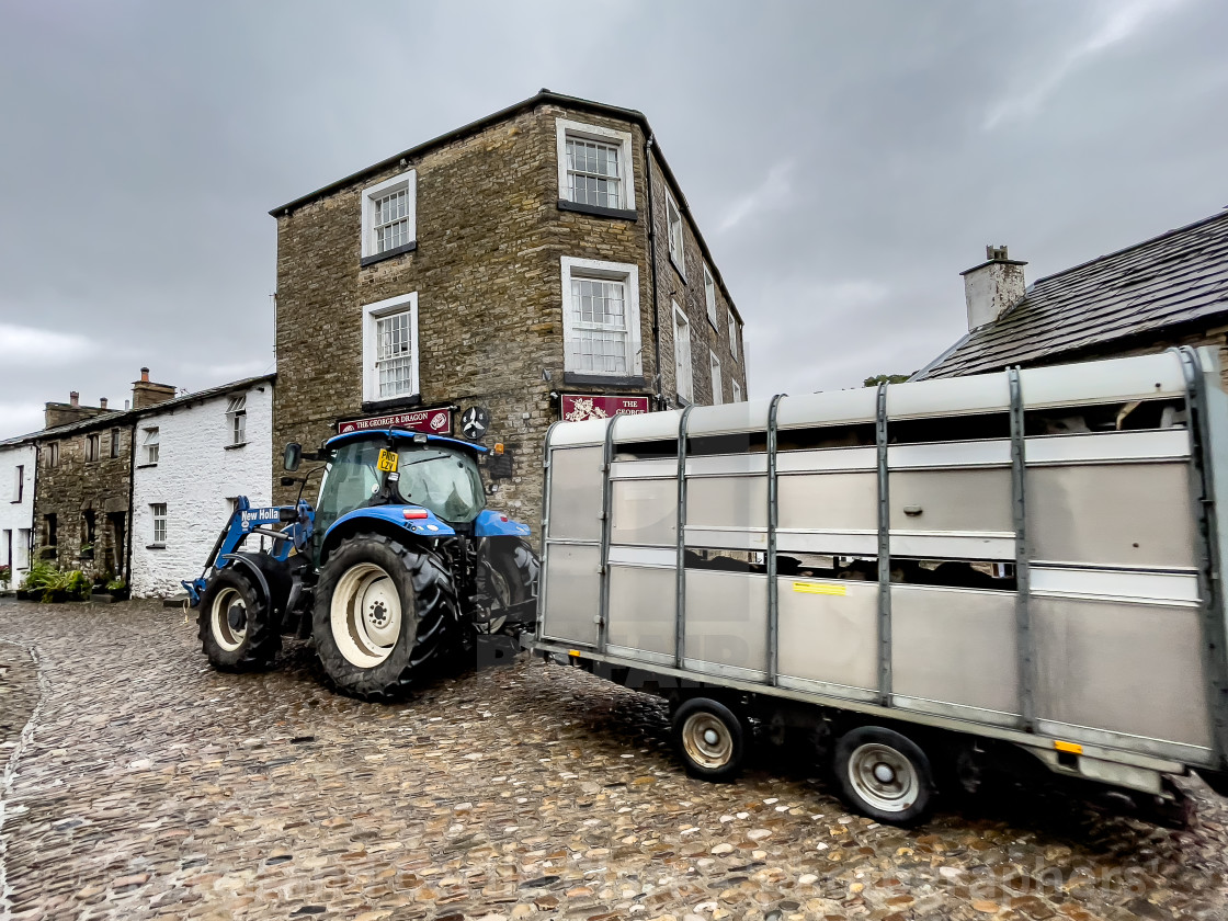 "Dent, Tractor Towing Livestock Trailer." stock image