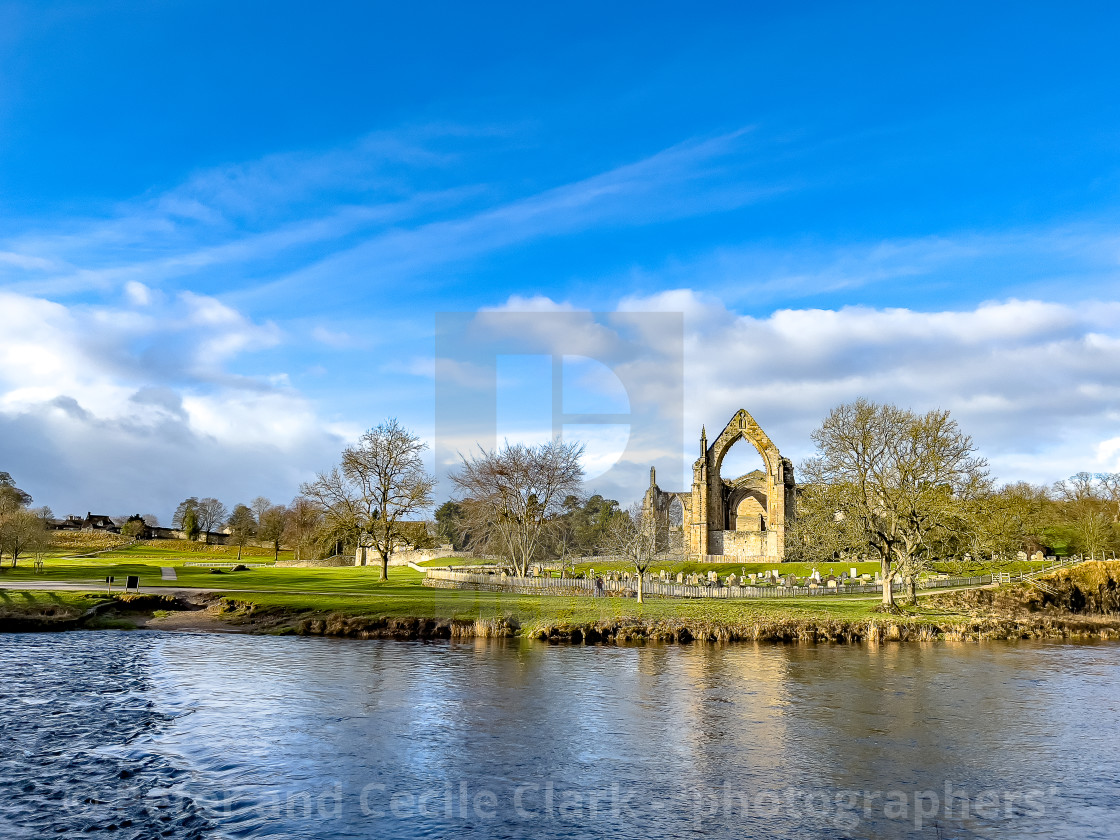 "River Wharfe and Stepping Stones, Bolton Abbey, Priory Ruins in the Background." stock image