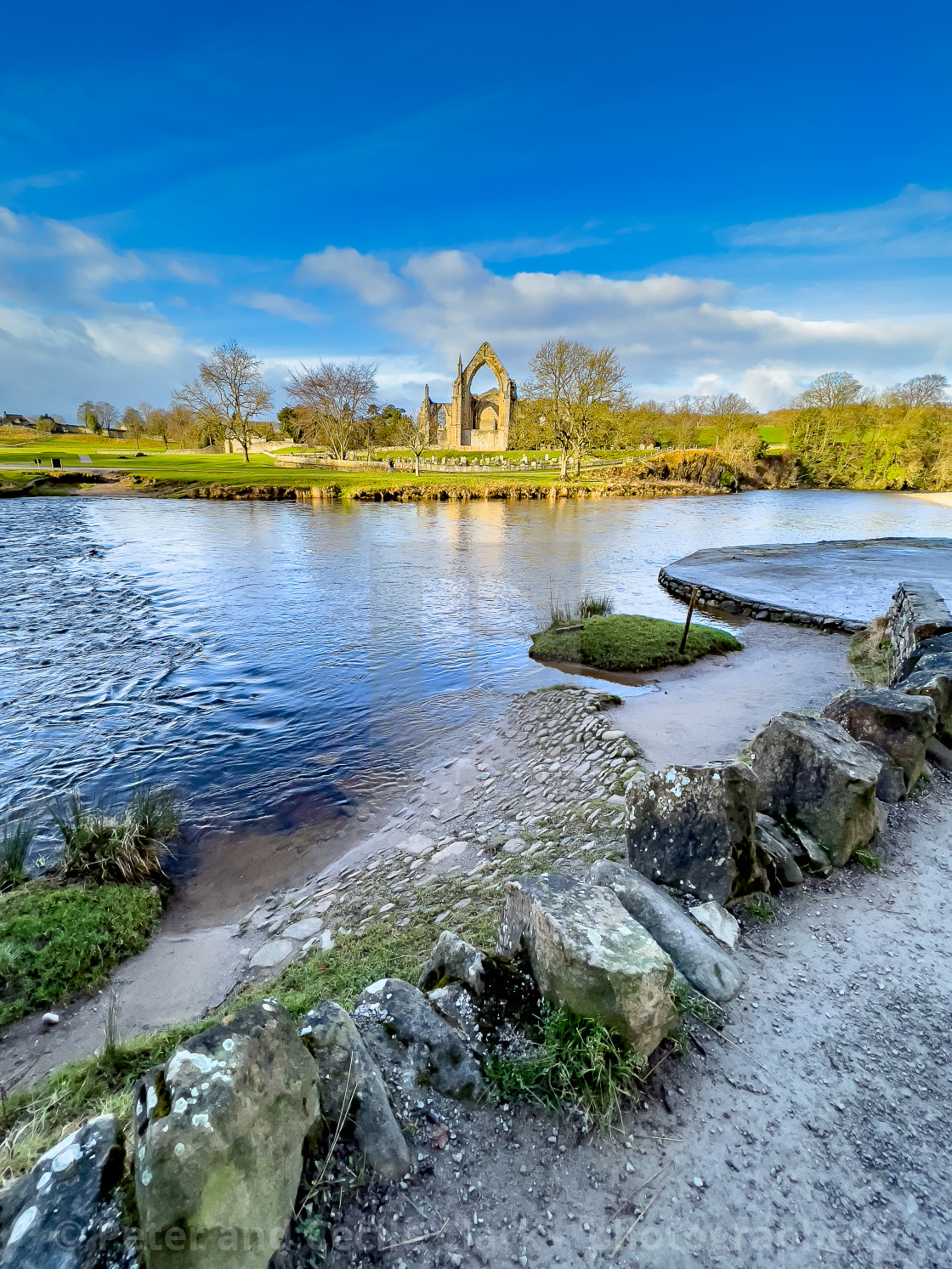 "River Wharfe and Stepping Stones, Bolton Abbey, Priory Ruins in the Background." stock image