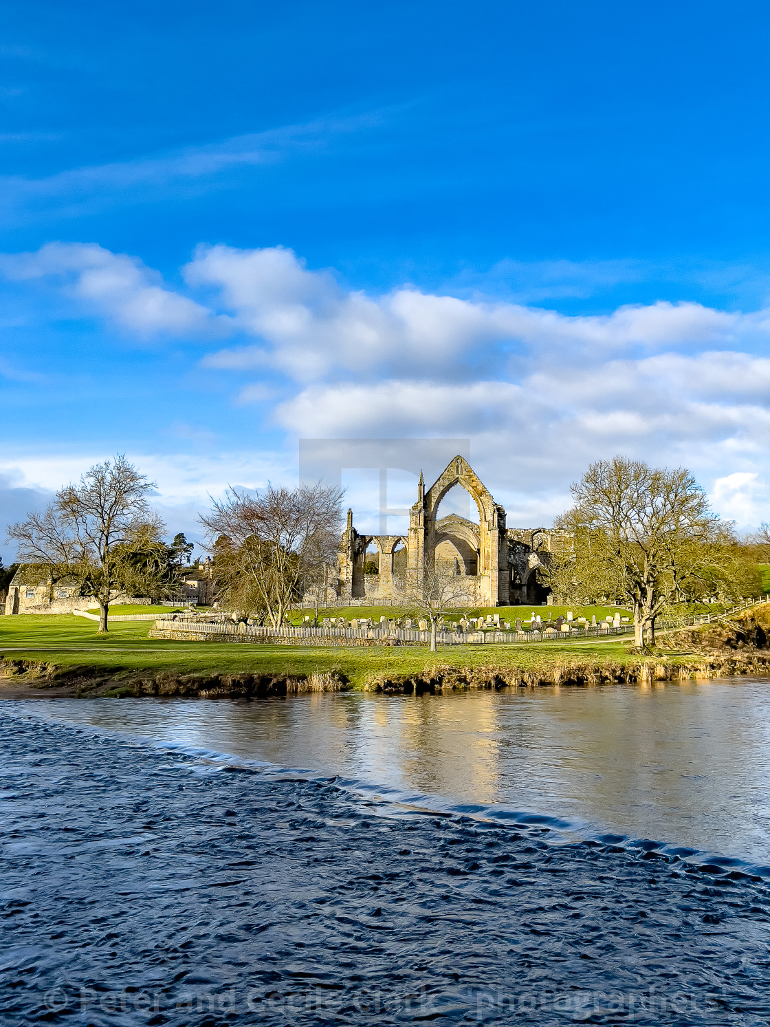 "River Wharfe and Stepping Stones, Bolton Abbey, Priory Ruins in the Background." stock image