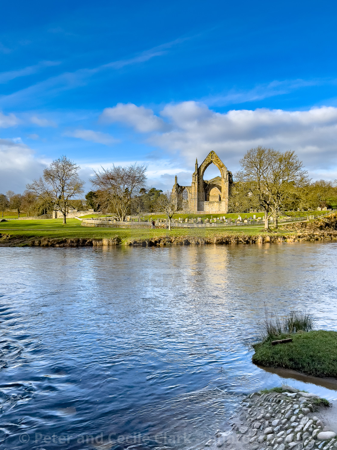 "River Wharfe and Stepping Stones, Bolton Abbey, Priory Ruins in the Background." stock image