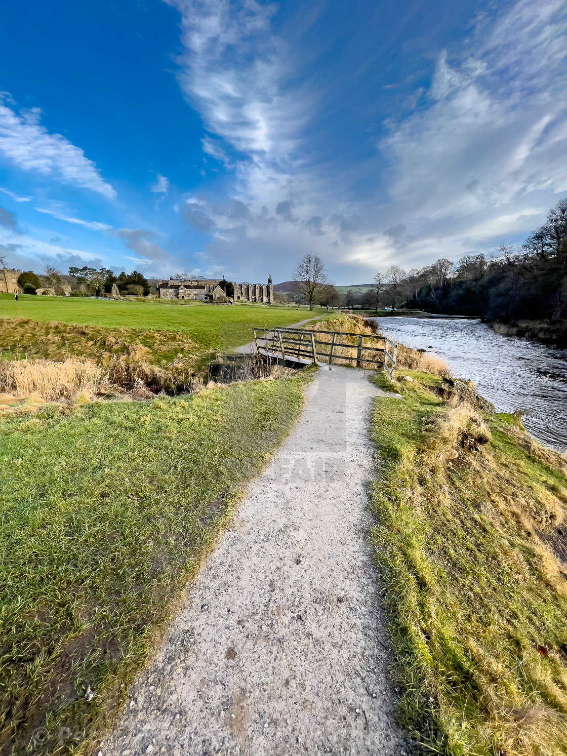 "River Wharfe, Footbridge, Bolton Abbey, Priory Ruins in the Background." stock image