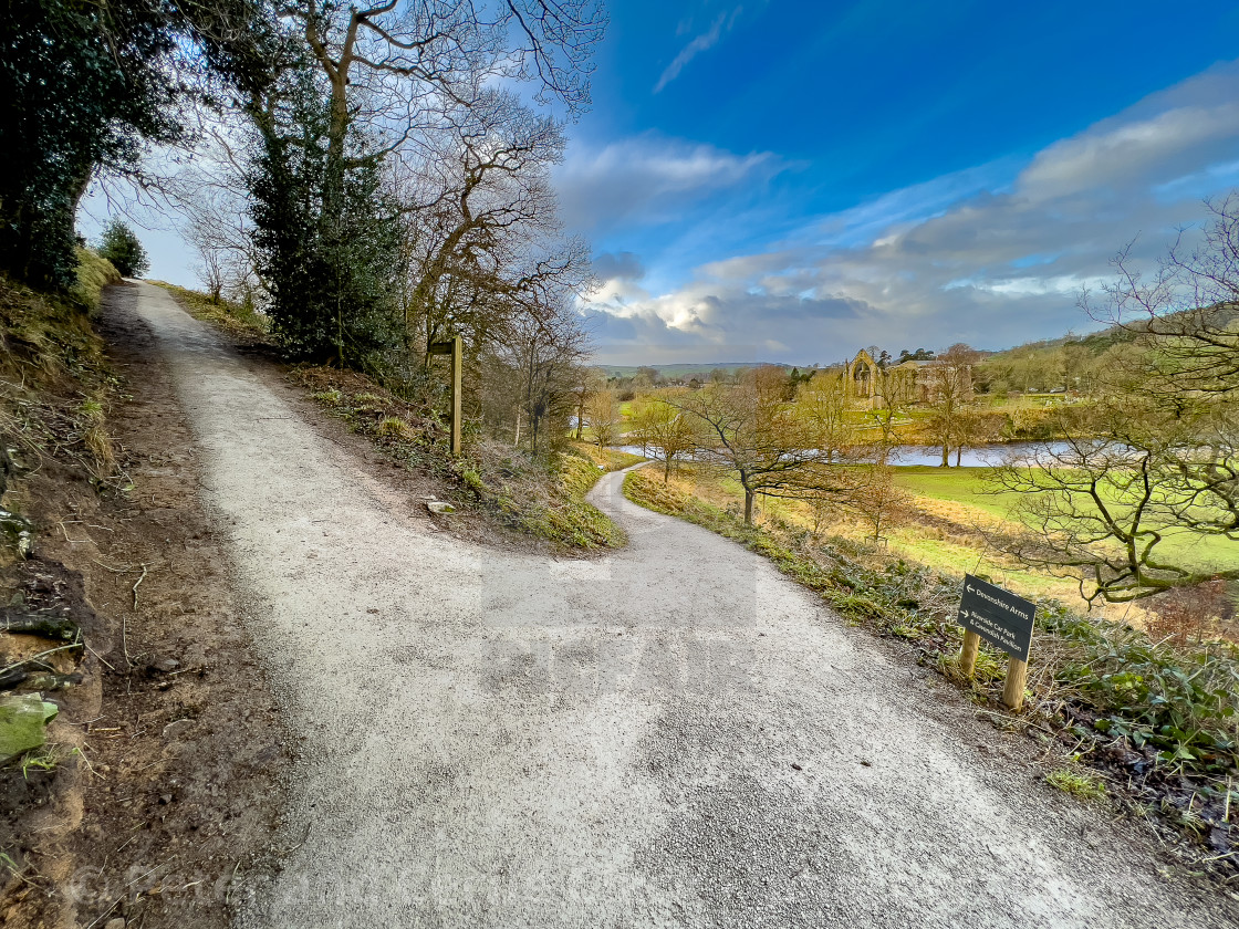 "River Wharfe, Footbridge, Bolton Abbey, Priory Ruins in the Background." stock image