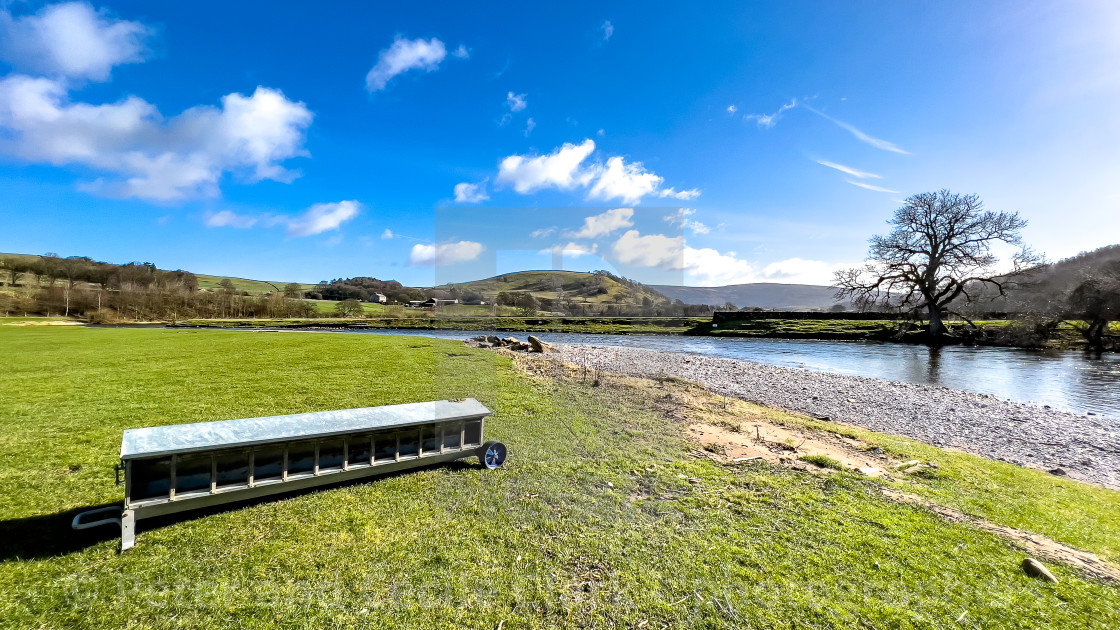 "Lamb Creep Feeder next to River Wharfe at Burnsall" stock image