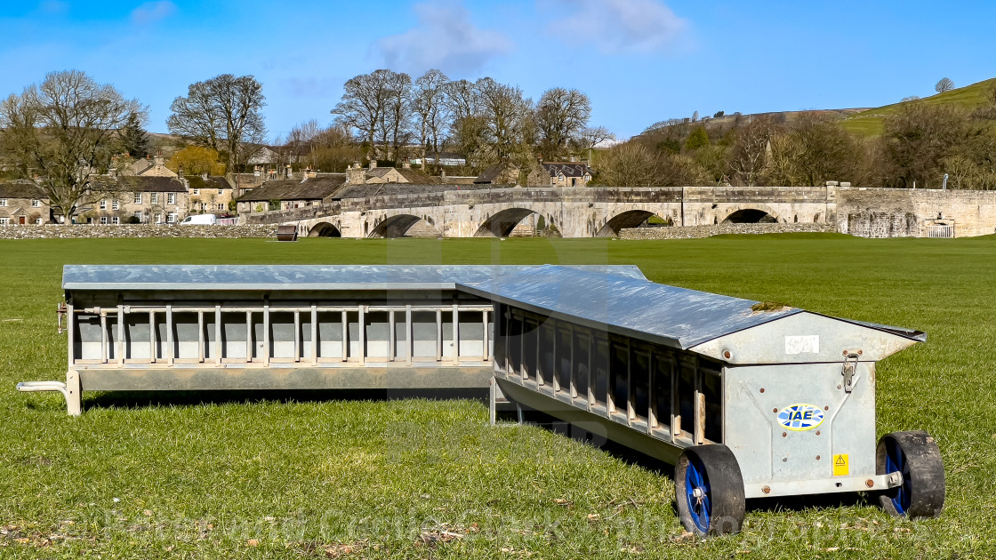 "Lamb Creep Feeders next to River Wharfe at Burnsall" stock image