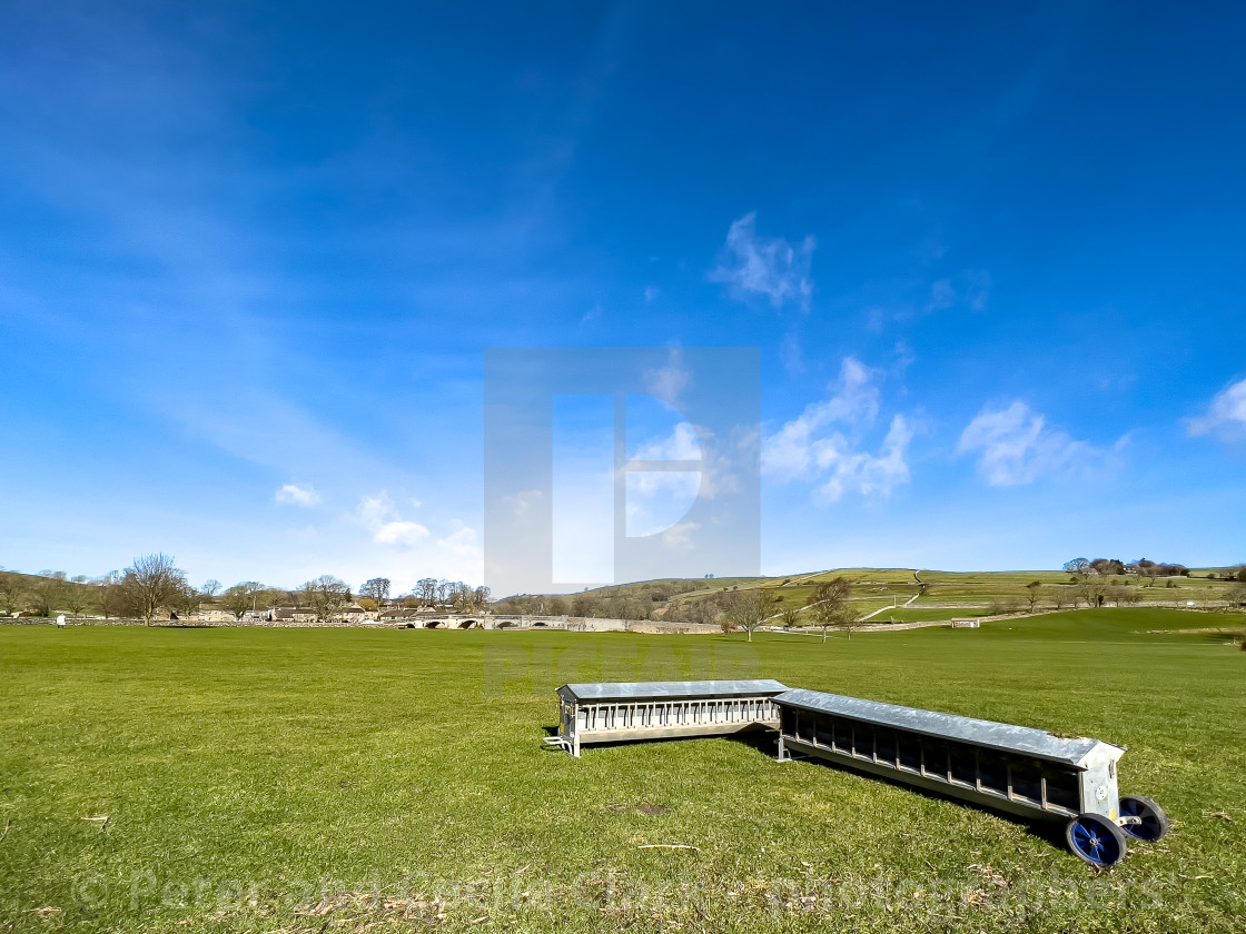 "Lamb Creep Feeders next to River Wharfe at Burnsall" stock image