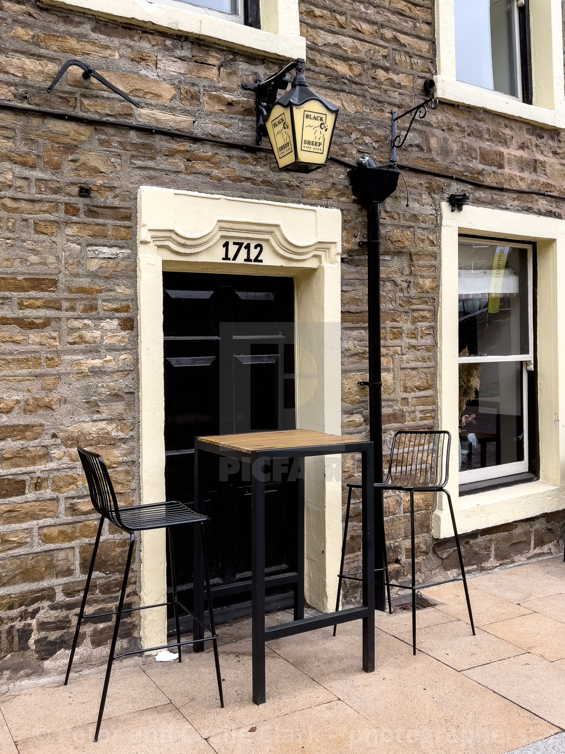 "Hawes, Bistro Seating and Dated Pub Doorway" stock image