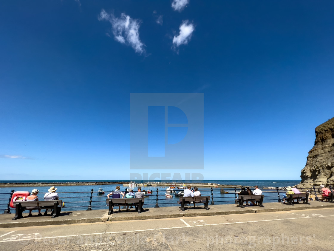 "Staithes, relaxing in sunshine, overlooking the harbour." stock image