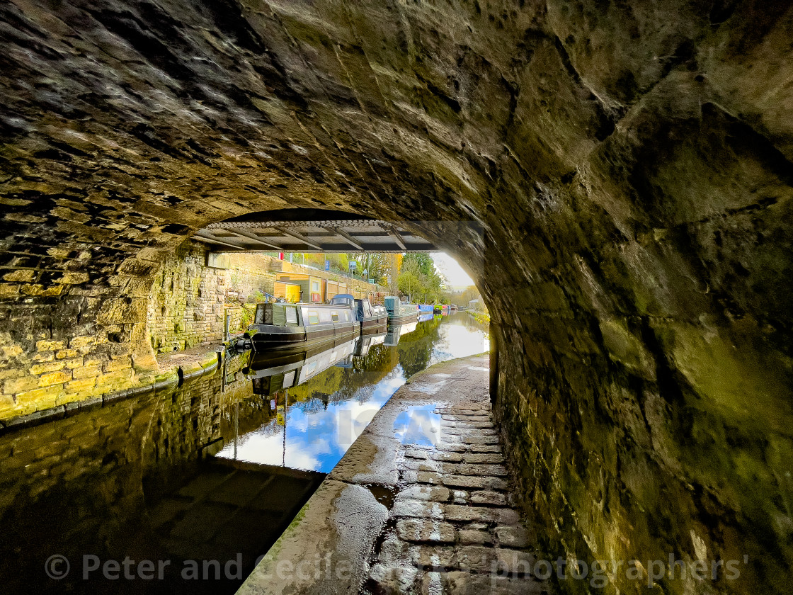 "Rochdale Canal Path under Bridge and Barge in background, Hebden Bridge." stock image