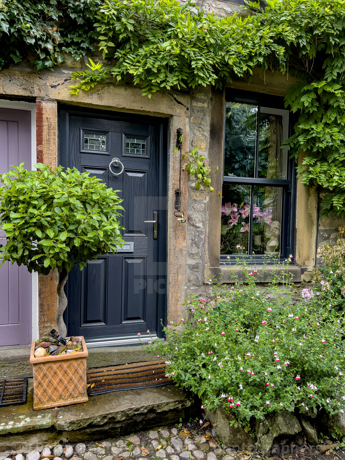 "Cobbled Street and Cottage in Grassington." stock image