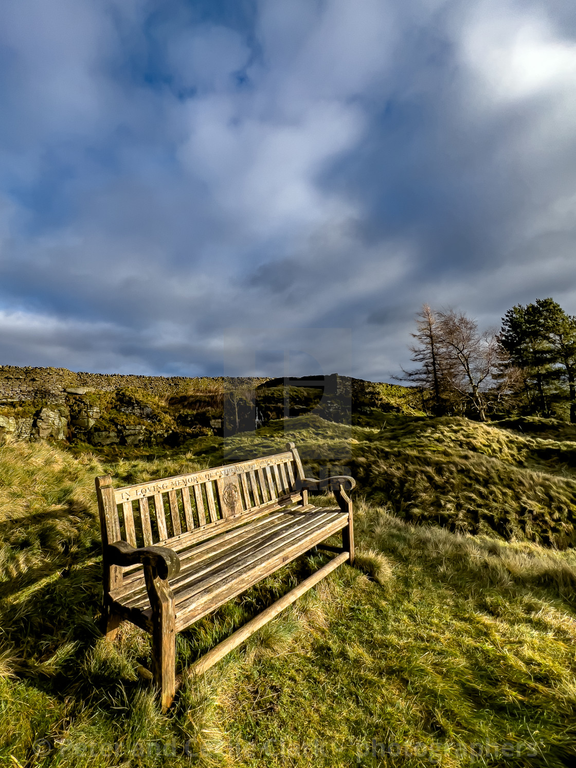 "Bench Seating and flower memorial with view over Grassington and the Yorkshire Dales, from Moor Lane, England, UK." stock image