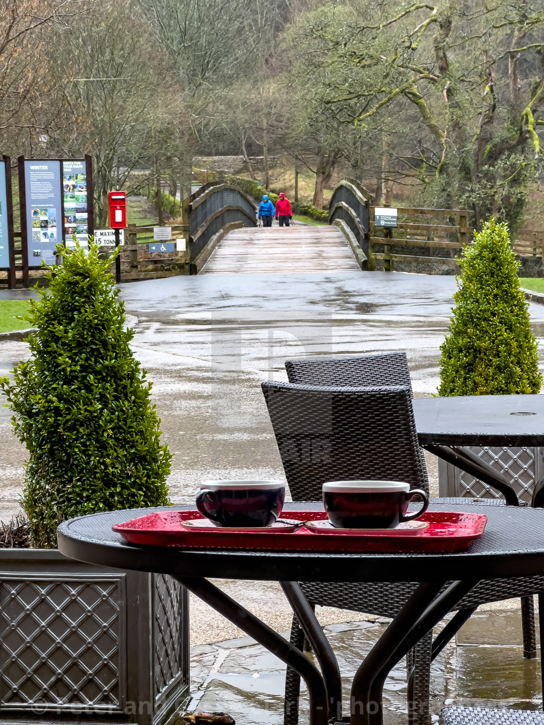 "Cavendish Pavilion, Bolton Abbey, Yorkshire Dales, England, UK. Outside seating and table with coffee cups in the rain." stock image