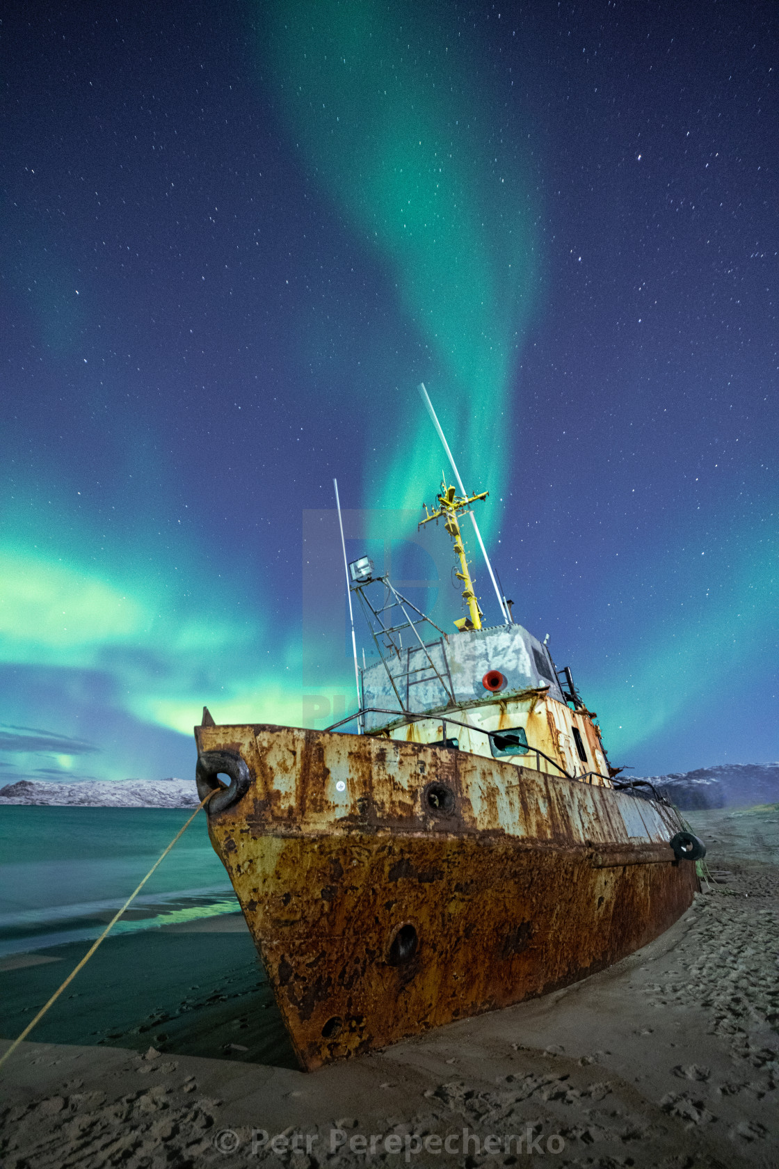 "Rusty boat under Northern lights" stock image