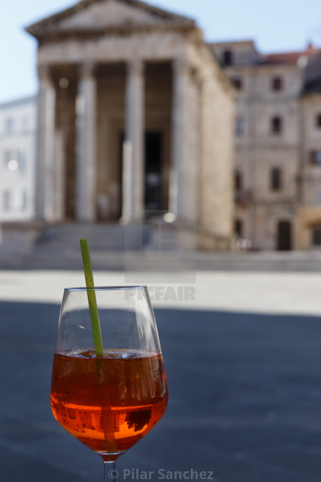 "Cocktail glass and Temple of Augustus on the background" stock image