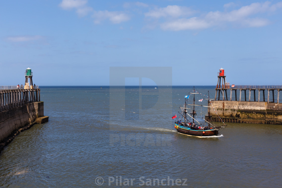 "Whitby harbour with a sailing boat" stock image