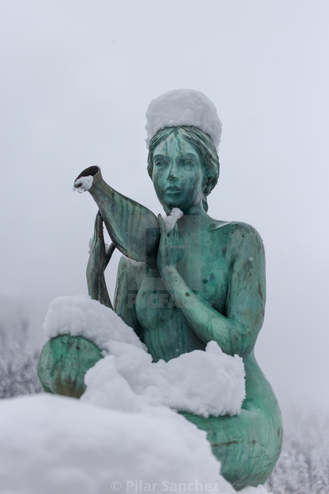 "Bronze statue in the snow" stock image