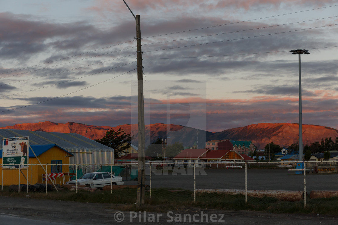 "Puerto Natales street and mountains view at sunset" stock image