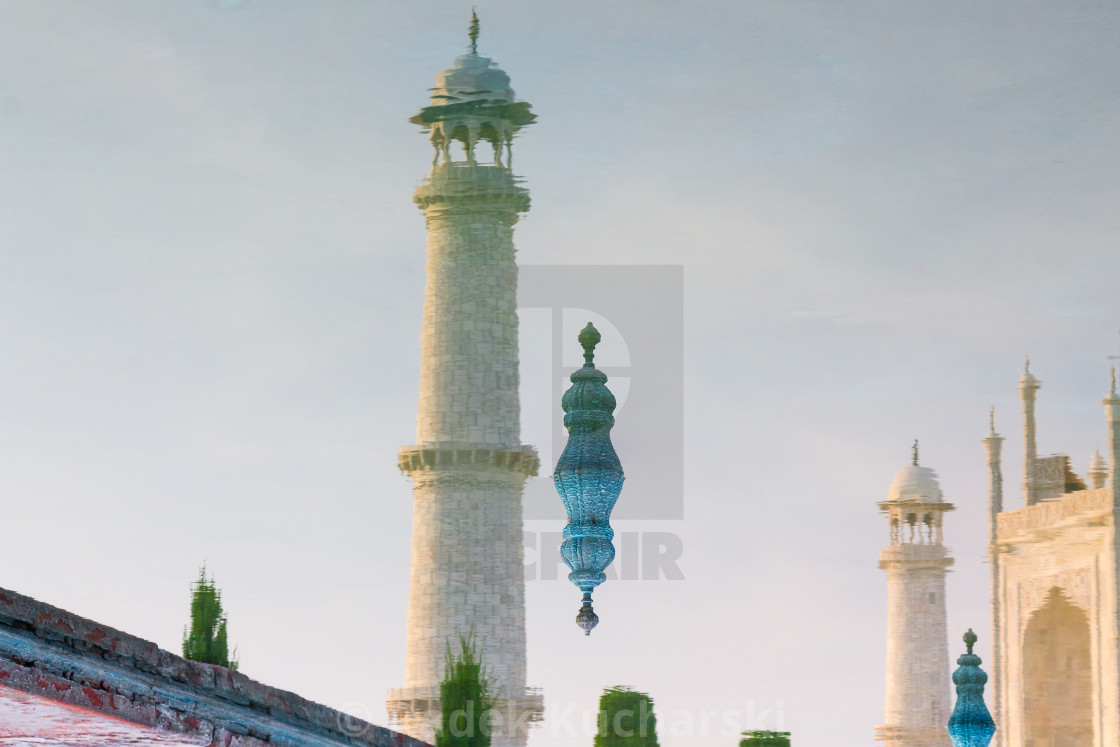 "Reflection of the Taj Mahal's minarets photographed in August. This famous mausoleum has been built for Mumtaz Mahal by her husband Shah Jahan, the emperor of India, after her death in 1961. It is a UNESCO World Heritage Site and the Wonder of the World." stock image