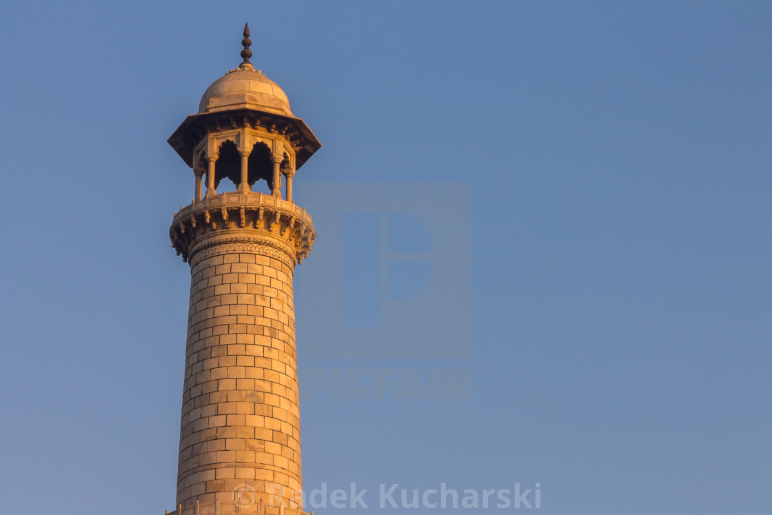 "Taj Mahal's minaret lit by the warm rays of the rising sun" stock image