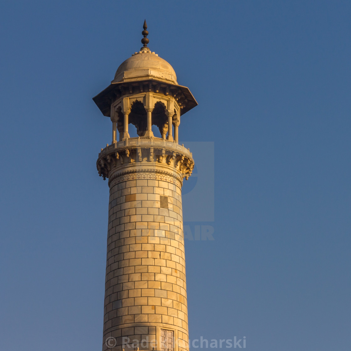 "Taj Mahal's minaret lit by the warm rays of the rising sun" stock image