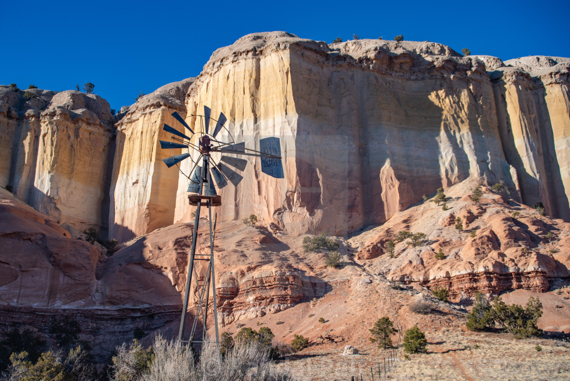 "Colorful sandstone cliffs with abandoned windmill" stock image