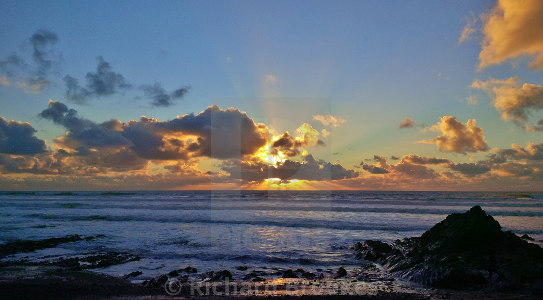 "BLAZE OF GLORY SUNBEAM SUNSET SANDYMOUTH CORNWALL" by Richard Brookes - $18.08 "BLAZE OF GLORY SUNBEAM SUNSET SANDYMOUTH CORNWALL" stock image
