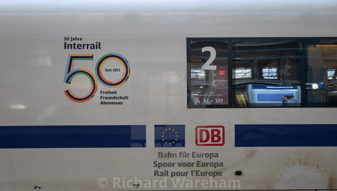 "Amsterdam The Netherlands 28th March 2024 Blue and white Deutsche Bahn ICE High speed international train to Frankfurt on the platform at Amsterdam Centraal Station. Logo for 50 years of Interrail," stock image