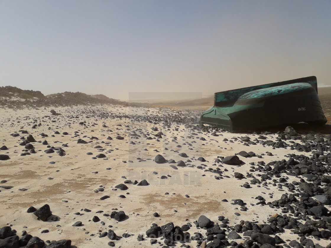 "Upturned boat on a windswept beach on Fuertventura" stock image