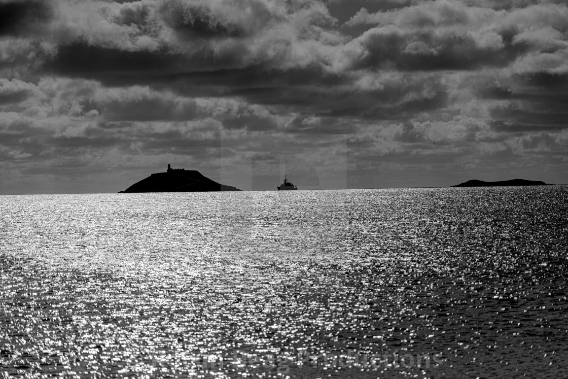 "Ballycotton Lighthouse & Navy Ship" stock image